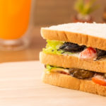 Foreign object, insects in sandwich on table Foreign object, insects in sandwich on table