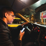 A guy looking at his phone while driving A guy looking at his phone while driving