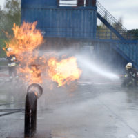 Firefighters extinguishing pipeline fire from accident