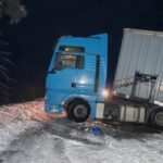 A real accident. Truck traffic accident at night, on a snowy winter road. Broken truck on the road in the snow.