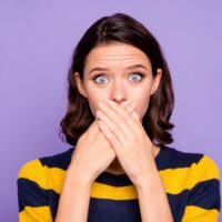 Close up photo beautiful amazing she her lady hiding mouth hands arms oh no expression eyes full fear know rumours speechless wear blue yellow striped pullover isolated violet purple background