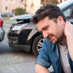 Driver portrait feeling pain after car accident