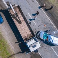 The truck and the car collided on the highway. Strong accident. Traffic accidents on the road. View from above. Traffic jam on the road.